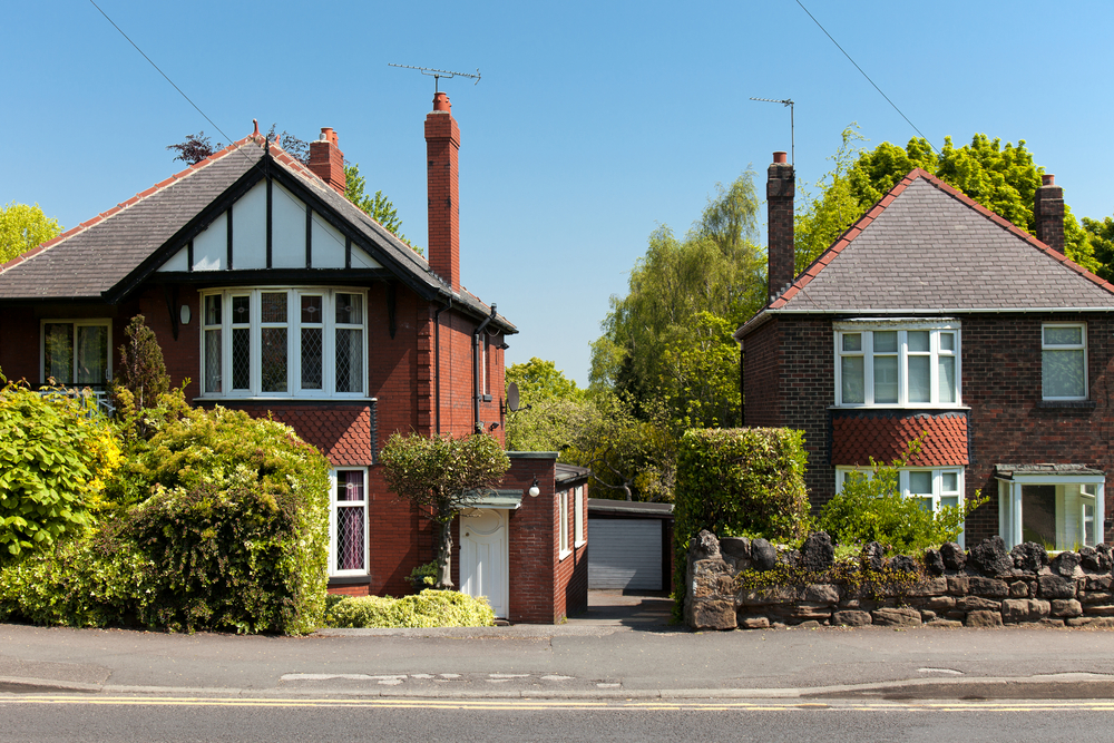 A street view of two detached homes